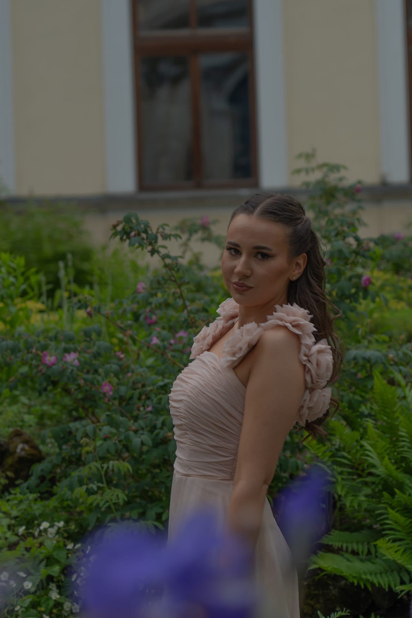Side portrait of Sumeja among garden roses