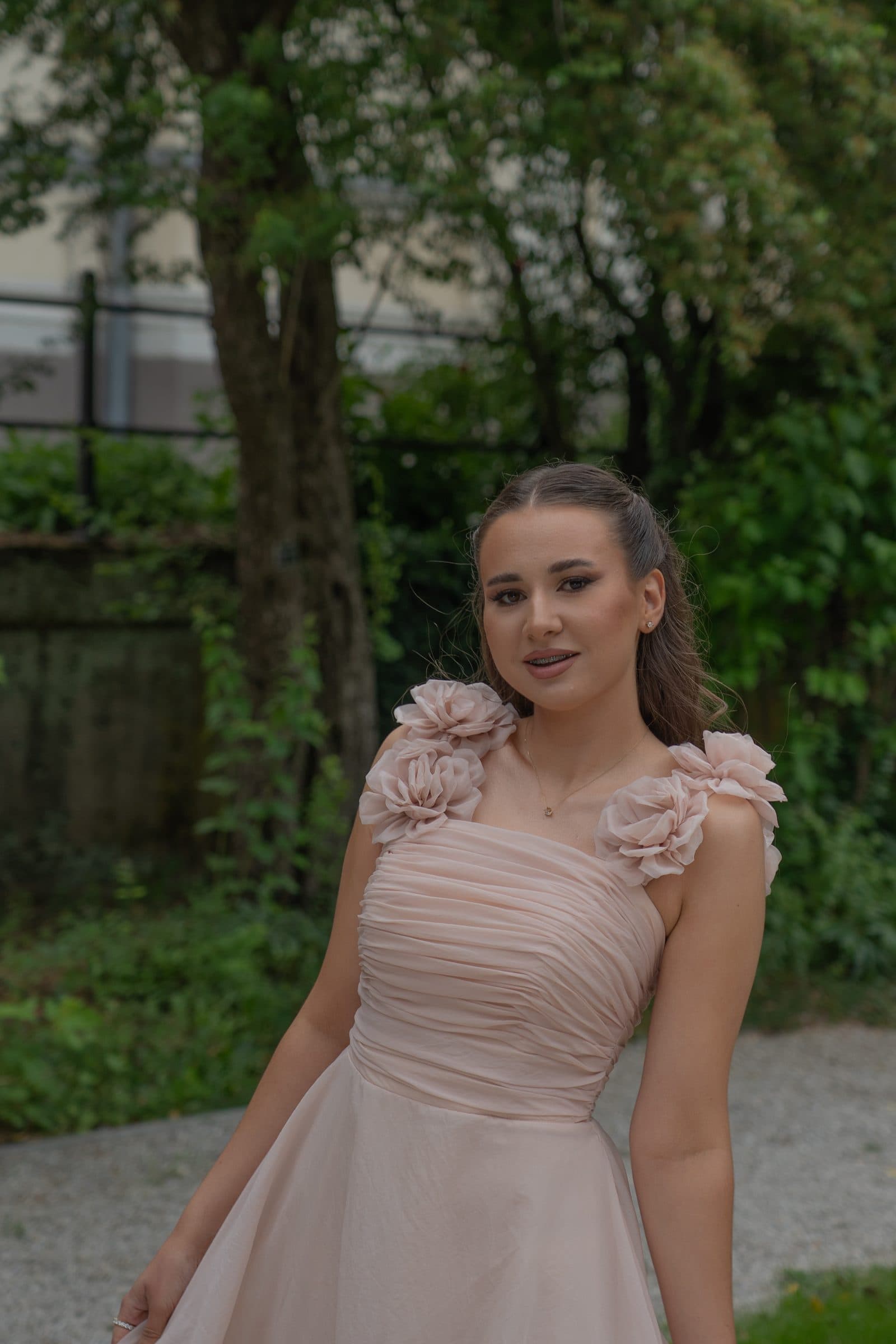 Smiling portrait of Sumeja in front of trees